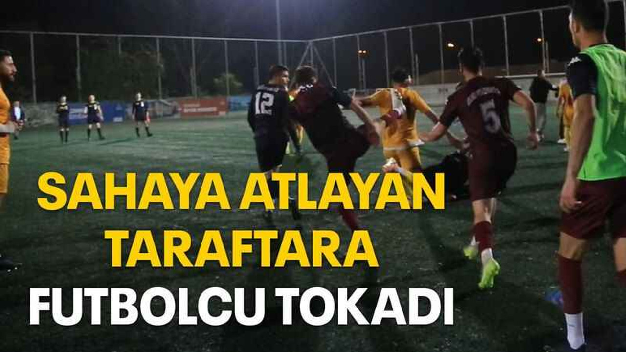 Sahaya atlayan taraftara futbolcu tokadı